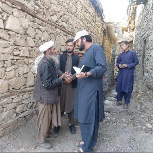 Abdulrahman Chonish, who leads our work on the ground, greeting a village elder in Nuristan