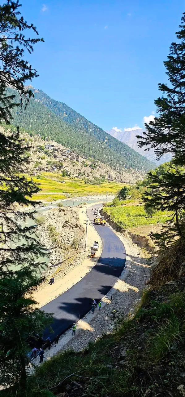 Road works along the river in the Kantiwa valley, Nuristan, with the mountains behind