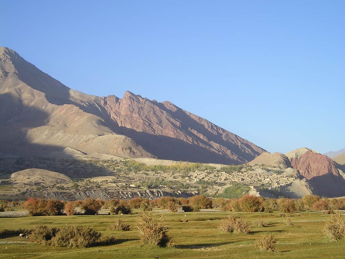 The broad, bare Kuran wa Munjan valley in Badakhshan under high mountains, looking west
