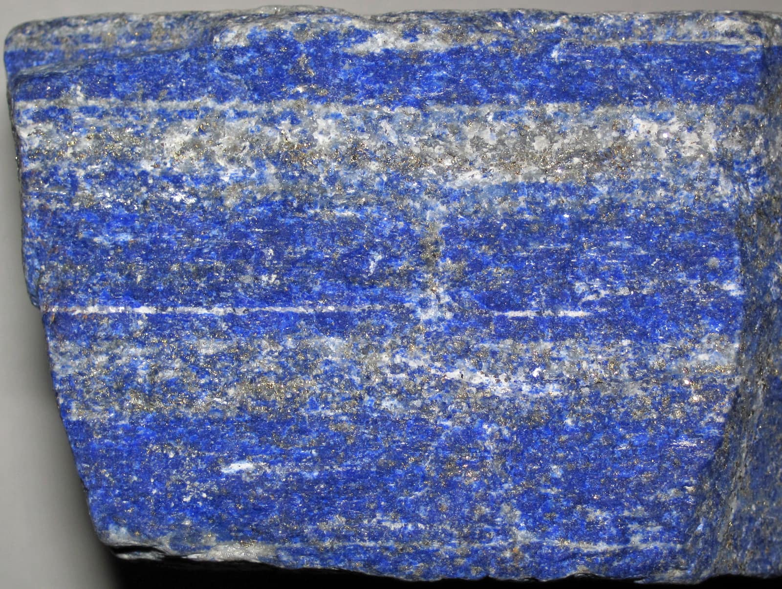 A polished slab of deep blue lapis lazuli flecked with gold pyrite from Sar-e Sang, Badakhshan