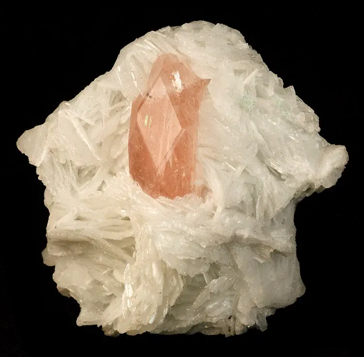 A peach morganite crystal of textbook hexagonal form, 3.5 centimetres across, set in bladed white cleavelandite, from Kunar province, Afghanistan