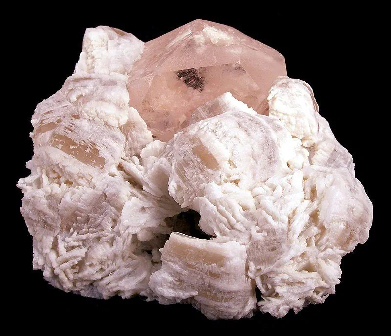 A sharp hexagonal pink morganite crystal, 4 centimetres across, standing in white bladed cleavelandite from the Pech valley pegmatite field in Kunar, Afghanistan
