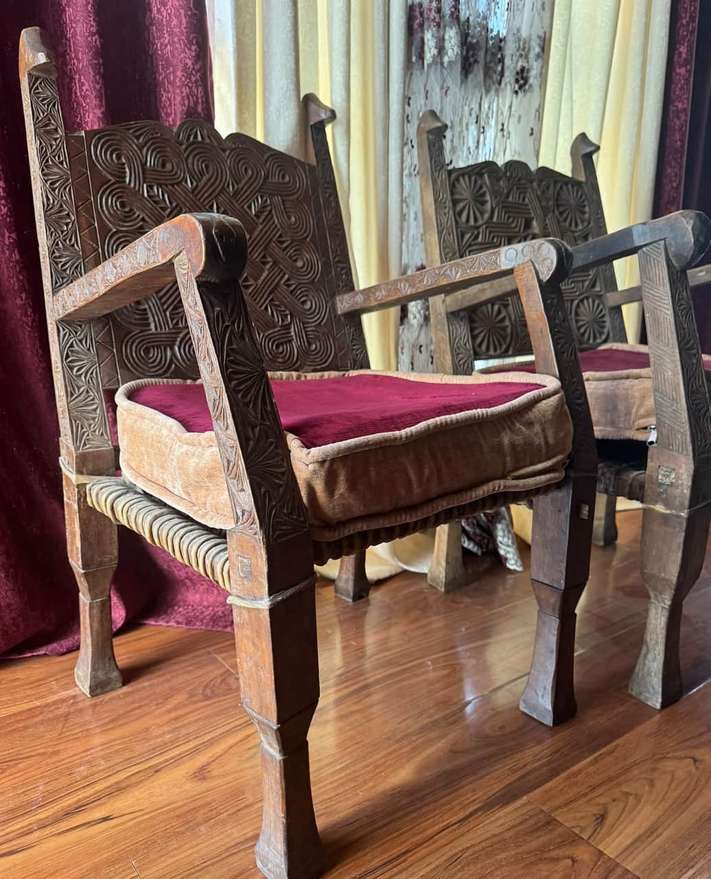 A carved Nuristani chair with a knotwork back