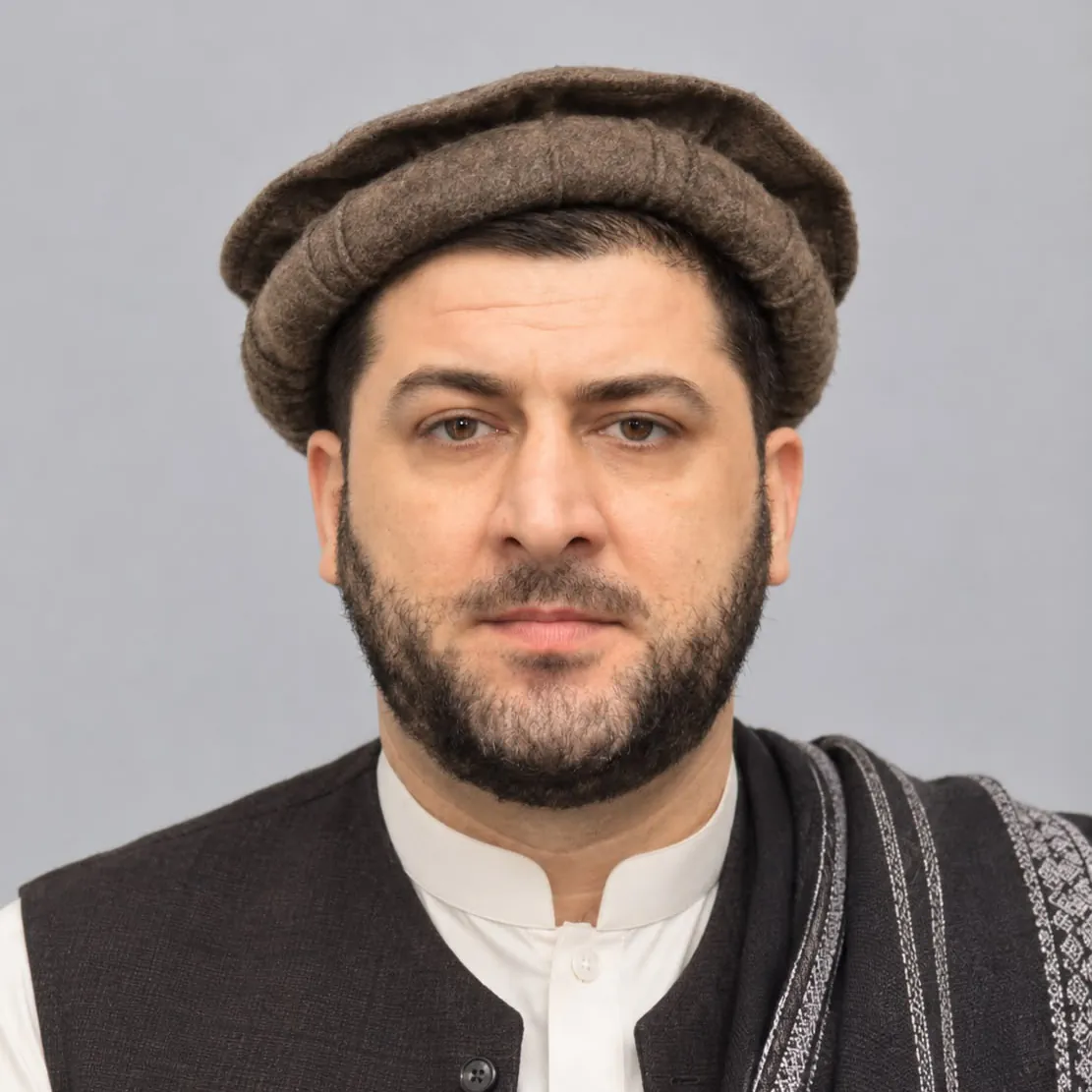 Zabiullah Amiri, director of Nuristani, in a brown pakol, a black waistcoat over a white shirt and a woven black and white shawl